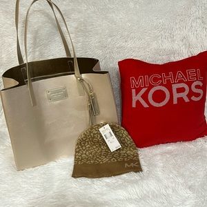 Extra large Michael Kors gold shopping tote with knit hat bundle.